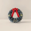 The Christmas wreath is hand-woven with pinecone balls to decorate the storefront wall, creating a festive atmosphere details Picture